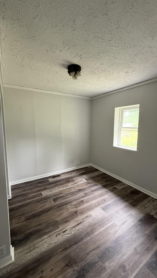 606 Prospect St, Berea, KY 40403 - spare room featuring a textured ceiling, dark wood-style floors, and baseboards