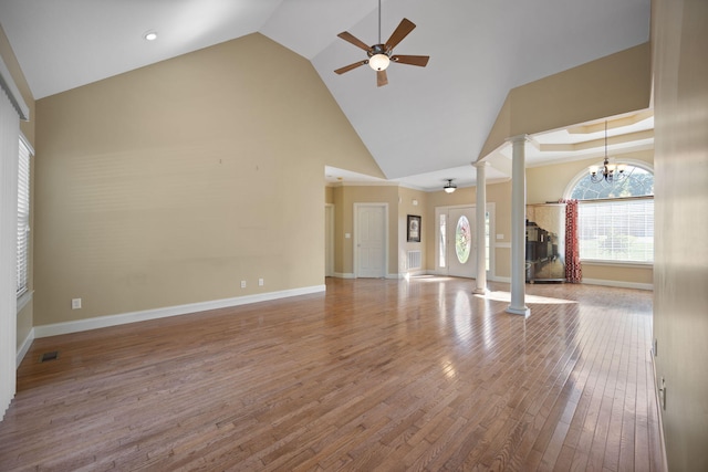 262 Silver Creek Dr, Somerset, KY 42503 - unfurnished living room featuring decorative columns, ceiling fan, high vaulted ceiling, wood finished floors, and baseboards