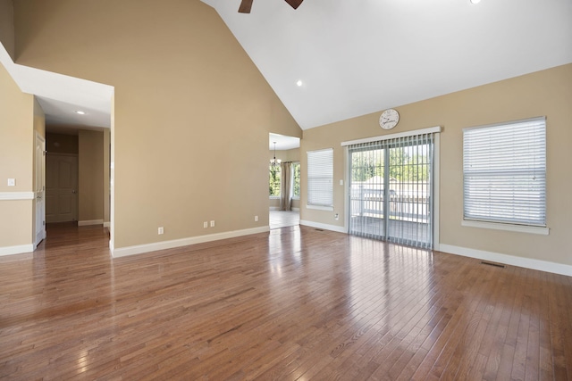 262 Silver Creek Dr, Somerset, KY 42503 - unfurnished living room featuring high vaulted ceiling, a ceiling fan, hardwood / wood-style floors, baseboards, and a chandelier