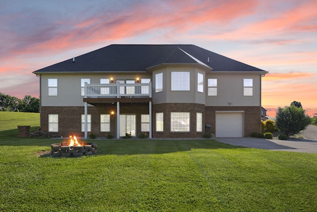 262 Silver Creek Dr, Somerset, KY 42503 - back of property with an outdoor fire pit, brick siding, asphalt driveway, and an attached garage
