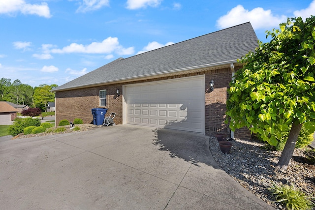 262 Silver Creek Dr, Somerset, KY 42503 - view of side of home featuring brick siding, driveway, a garage, and a shingled roof