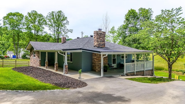 110 Witt Rd, London, KY 40741 - rear view of property with covered porch, a chimney, roof with shingles, and stone siding