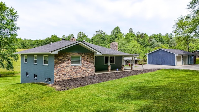 110 Witt Rd, London, KY 40741 - view of home's exterior featuring a chimney, a lawn, stone siding, a detached garage, and an outdoor structure