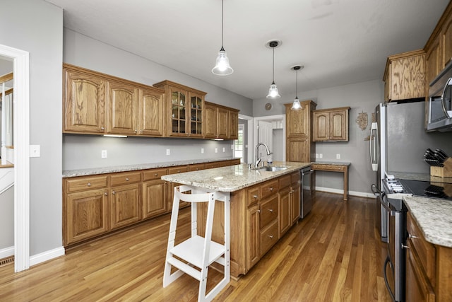 164 River Run Dr, Lancaster, KY 40444 - kitchen featuring appliances with stainless steel finishes, a sink, brown cabinets, and wood finished floors