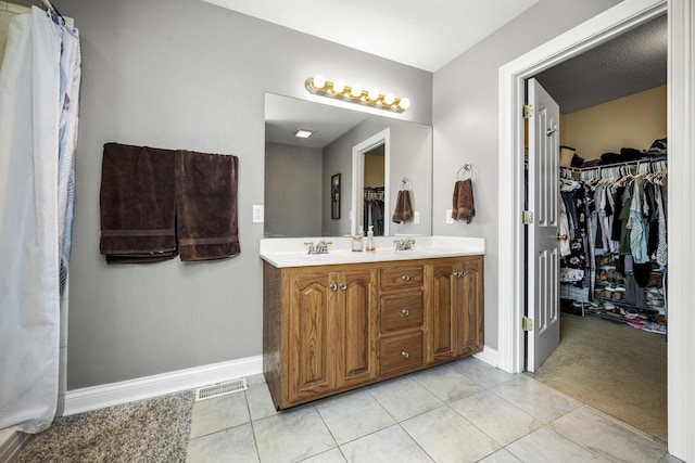 164 River Run Dr, Lancaster, KY 40444 - full bathroom with baseboards, a walk in closet, double vanity, and tile patterned floors