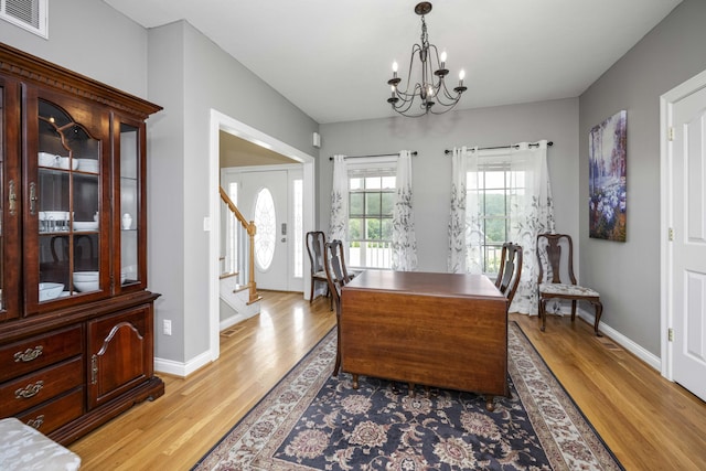 164 River Run Dr, Lancaster, KY 40444 - dining room featuring light wood finished floors, a chandelier, stairs, baseboards, and an office area