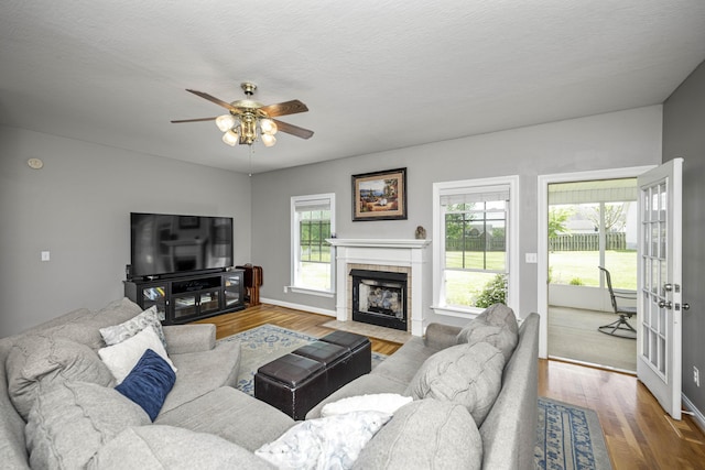 164 River Run Dr, Lancaster, KY 40444 - living room with a ceiling fan, wood finished floors, a tile fireplace, and baseboards