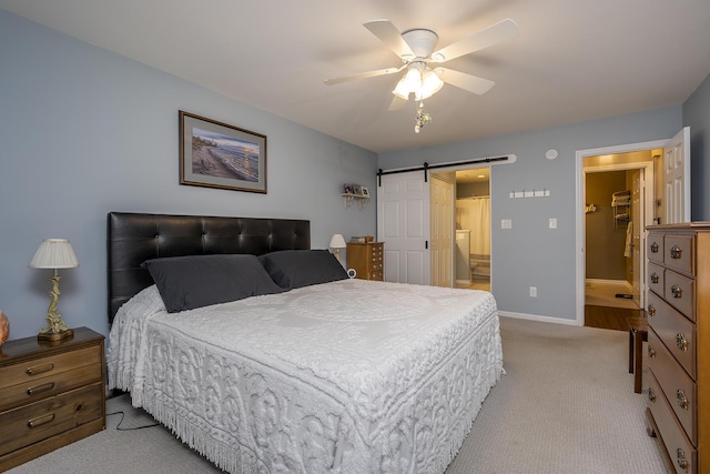 395 Redding Rd Unit 19, Lexington, KY 40517 - bedroom featuring a barn door, light colored carpet, baseboards, and a ceiling fan