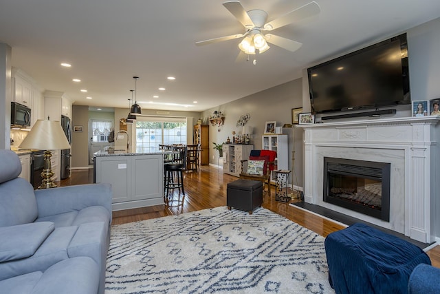 395 Redding Rd Unit 19, Lexington, KY 40517 - living room featuring dark wood-type flooring, recessed lighting, ceiling fan, baseboards, and a fireplace