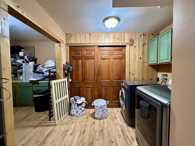 5080 Dry Branch Rd, Lexington, KY 40515 - washroom featuring washer and clothes dryer, light wood-style floors, cabinet space, and wood walls