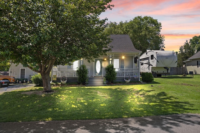 81 Coffey Ave, Jamestown, KY 42629 - view of front of property with covered porch, a lawn, and a shingled roof