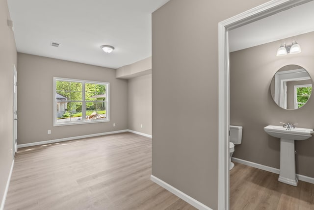 306 Young St, Georgetown, KY 40324 - half bath with toilet, wood finished floors, baseboards, and a sink
