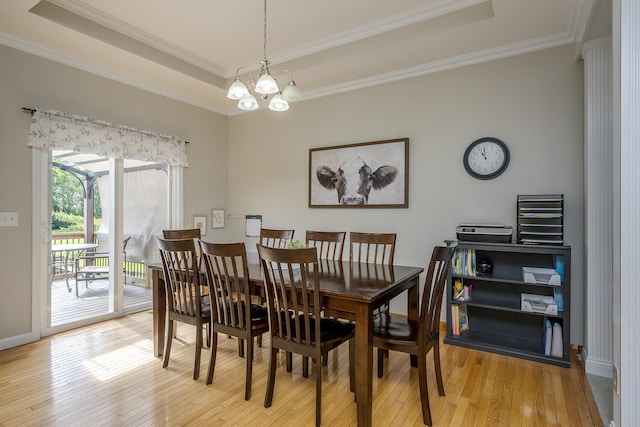 2018 E Ct, Richmond, KY 40475 - dining room with a tray ceiling, light wood finished floors, a chandelier, crown molding, and baseboards