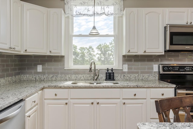 2018 E Ct, Richmond, KY 40475 - kitchen with appliances with stainless steel finishes, a sink, white cabinets, and decorative backsplash