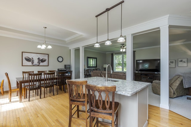2018 E Ct, Richmond, KY 40475 - kitchen with decorative columns, light wood finished floors, light stone counters, a ceiling fan, and crown molding