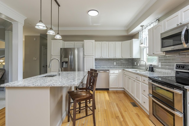 2018 E Ct, Richmond, KY 40475 - kitchen with stainless steel appliances, a sink, backsplash, crown molding, and white cabinetry