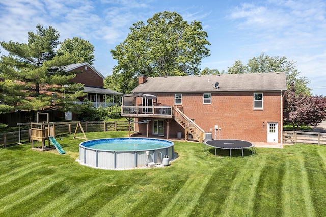 2018 E Ct, Richmond, KY 40475 - back of property featuring stairs, a trampoline, a deck, a chimney, and an outdoor pool