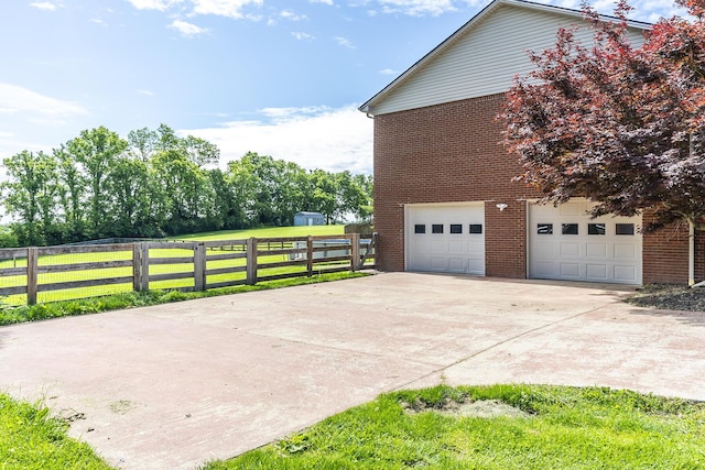 2018 E Ct, Richmond, KY 40475 - view of side of home featuring brick siding, an attached garage, and driveway