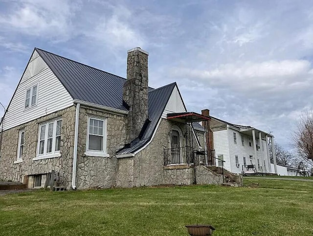 504 Burkesville St, Columbia, KY 42728 - view of home's exterior featuring a chimney, a lawn, a standing seam roof, and stone siding