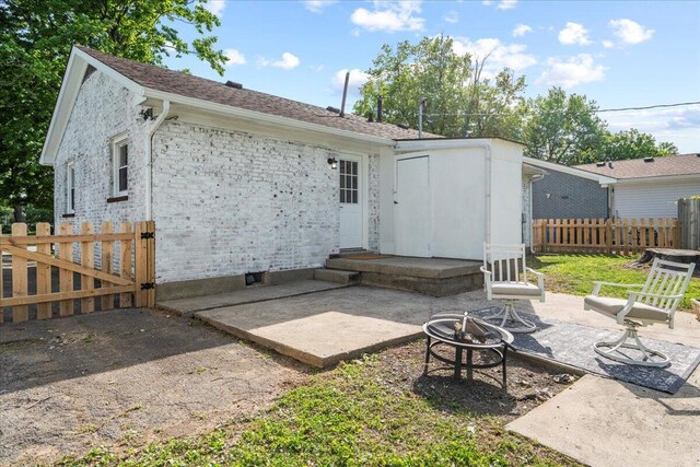 161 Toronto Rd, Lexington, KY 40515 - back of property with an outdoor fire pit, a patio area, and a gate