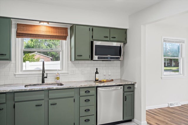 161 Toronto Rd, Lexington, KY 40515 - kitchen with green cabinetry, appliances with stainless steel finishes, a sink, and backsplash