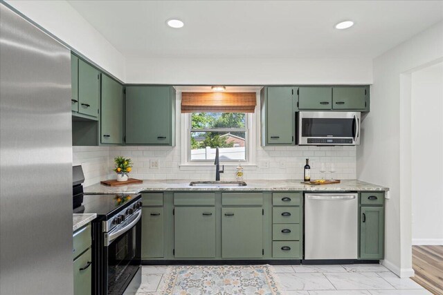 161 Toronto Rd, Lexington, KY 40515 - kitchen featuring appliances with stainless steel finishes, green cabinetry, a sink, tasteful backsplash, and recessed lighting
