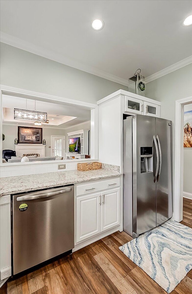 4172 Tradition Way, Lexington, KY 40509 - kitchen with appliances with stainless steel finishes, crown molding, white cabinets, dark wood-style flooring, and light stone counters