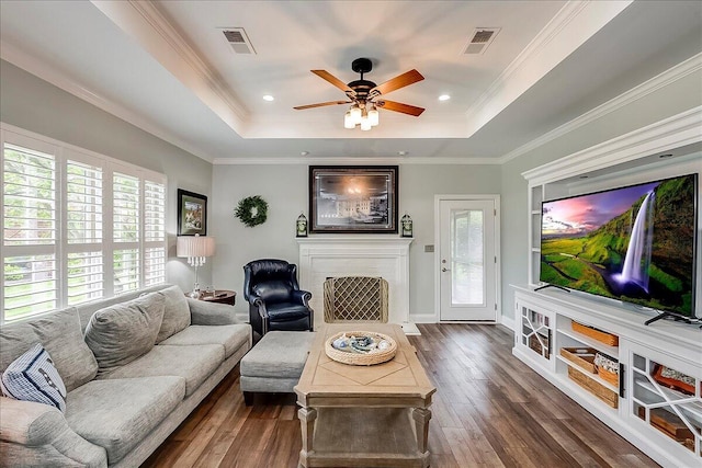 4172 Tradition Way, Lexington, KY 40509 - living area with a tray ceiling, dark wood finished floors, a ceiling fan, a brick fireplace, and crown molding
