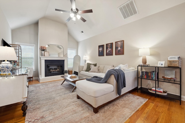 112 Woods Point Cir, Georgetown, KY 40324 - living room with wood finished floors, a ceiling fan, high vaulted ceiling, a fireplace with raised hearth, and baseboards