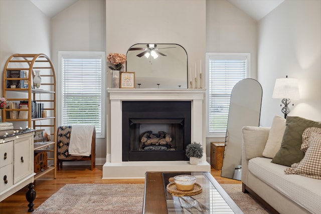 112 Woods Point Cir, Georgetown, KY 40324 - living area featuring wood finished floors, a fireplace with raised hearth, a ceiling fan, and high vaulted ceiling