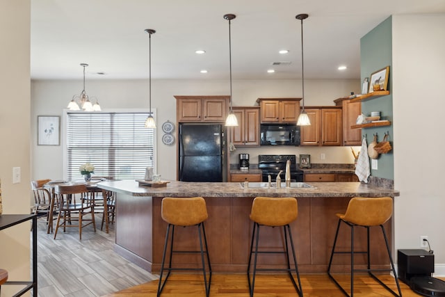 112 Woods Point Cir, Georgetown, KY 40324 - kitchen with black appliances, a kitchen breakfast bar, open shelves, dark countertops, and a peninsula