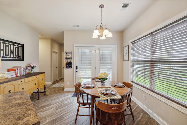 112 Woods Point Cir, Georgetown, KY 40324 - dining area with a chandelier, healthy amount of natural light, and light wood-style floors