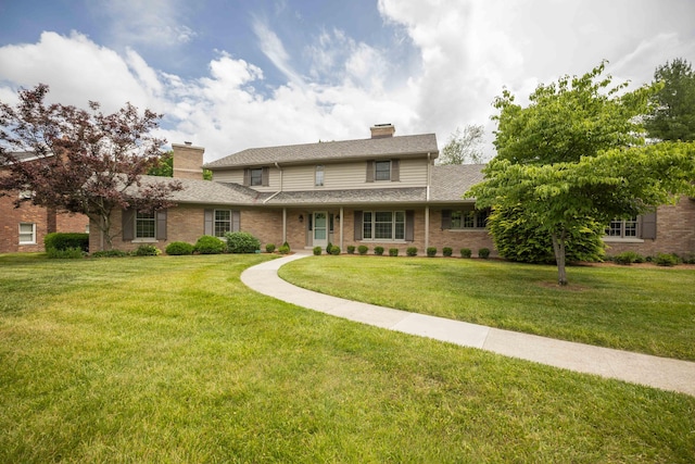 804 Old Dobbin Rd, Lexington, KY 40502 - traditional home with a chimney, a front yard, and brick siding