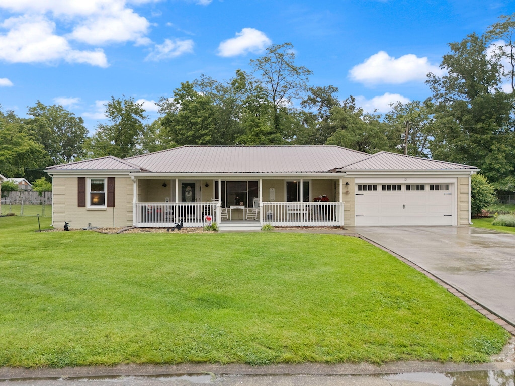 13 Robyn Dr, Winchester, KY 40391 - single story home featuring a porch, metal roof, concrete driveway, a front lawn, and a garage