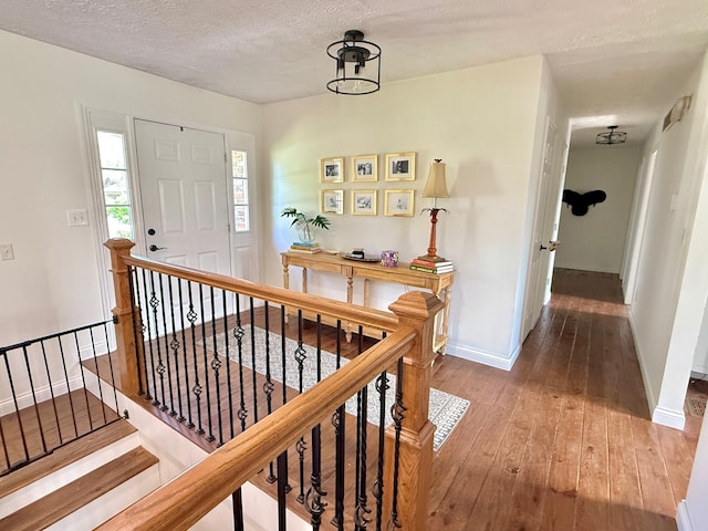 100 Cave Run Rd, Frankfort, KY 40601 - foyer entrance with wood-type flooring, baseboards, a textured ceiling, and stairs