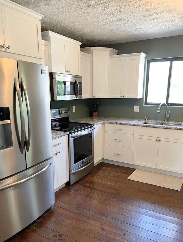 100 Cave Run Rd, Frankfort, KY 40601 - kitchen featuring appliances with stainless steel finishes, a sink, dark wood-style flooring, white cabinetry, and a textured ceiling