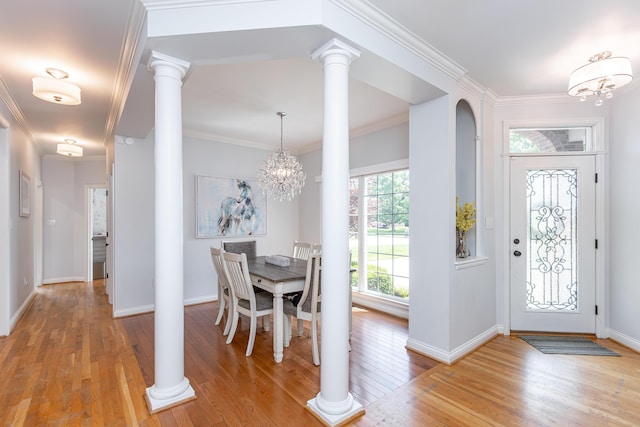 209 Juniper Dr, Nicholasville, KY 40356 - foyer with a chandelier, light wood-style flooring, crown molding, decorative columns, and arched walkways