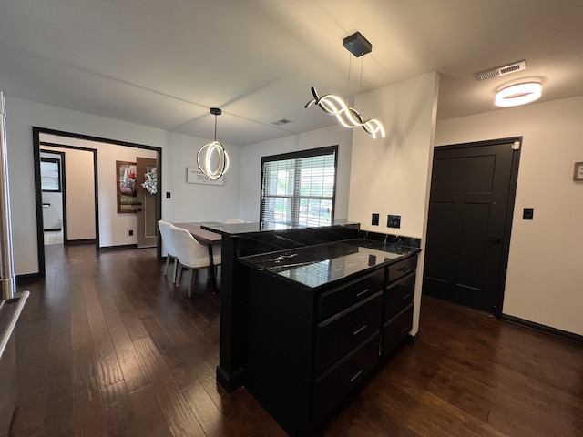 101 Dorset Ln, Winchester, KY 40391 - kitchen featuring dark cabinets, dark wood-type flooring, hanging light fixtures, and baseboards