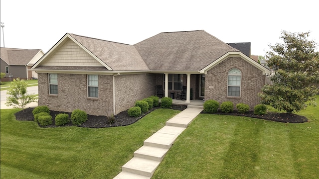 101 Dorset Ln, Winchester, KY 40391 - ranch-style home featuring a front yard, brick siding, covered porch, and roof with shingles