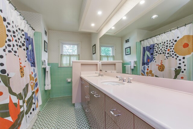 339 Greenbriar Rd, Lexington, KY 40503 - bathroom with wallpapered walls, double vanity, tile walls, a shower with shower curtain, and recessed lighting