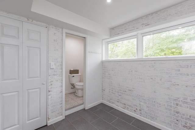 339 Greenbriar Rd, Lexington, KY 40503 - bathroom featuring toilet, tile patterned floors, baseboards, and a closet