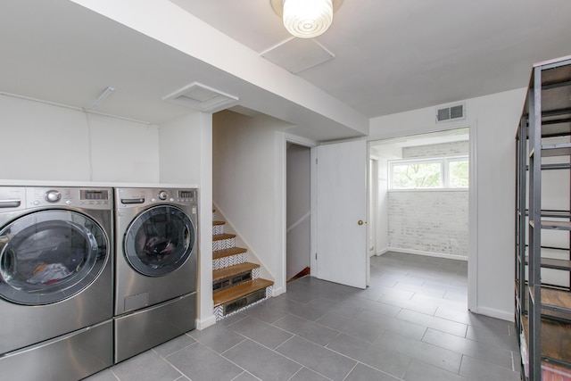 339 Greenbriar Rd, Lexington, KY 40503 - laundry room with washer and clothes dryer, dark tile patterned flooring, and baseboards