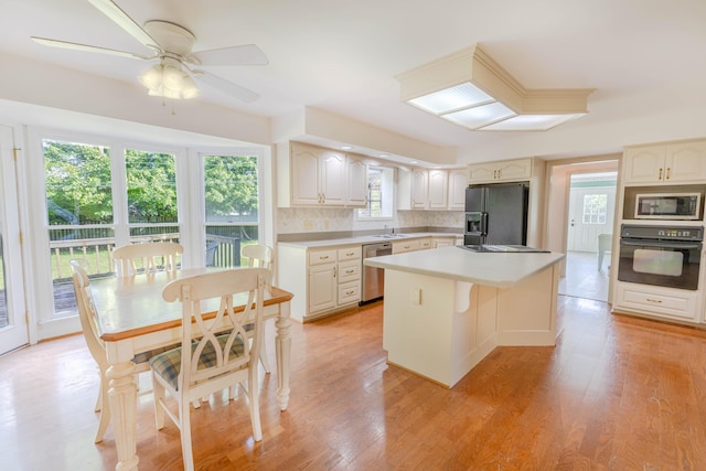 6011 Canonero Way, Versailles, KY 40383 - kitchen with black appliances, decorative backsplash, a kitchen island, ceiling fan, and light countertops