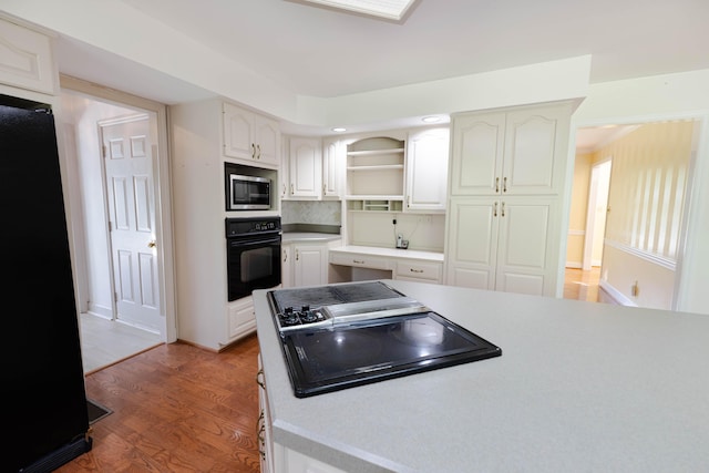 6011 Canonero Way, Versailles, KY 40383 - kitchen featuring black appliances, wood finished floors, open shelves, light countertops, and decorative backsplash