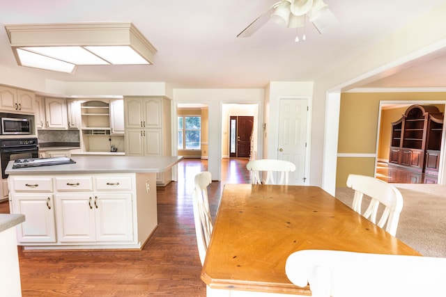 6011 Canonero Way, Versailles, KY 40383 - kitchen with stainless steel microwave, oven, a center island, and wood finished floors