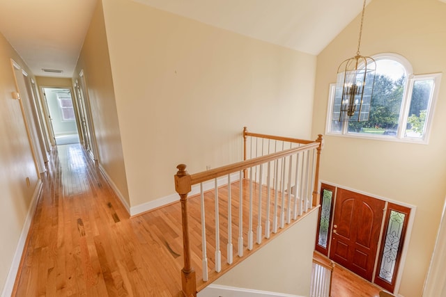 6011 Canonero Way, Versailles, KY 40383 - entrance foyer featuring wood finished floors, a chandelier, baseboards, and vaulted ceiling