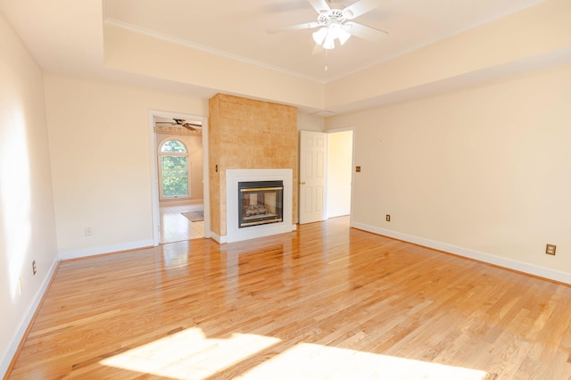 6011 Canonero Way, Versailles, KY 40383 - unfurnished living room featuring a ceiling fan, light wood-style flooring, baseboards, a tiled fireplace, and ornamental molding