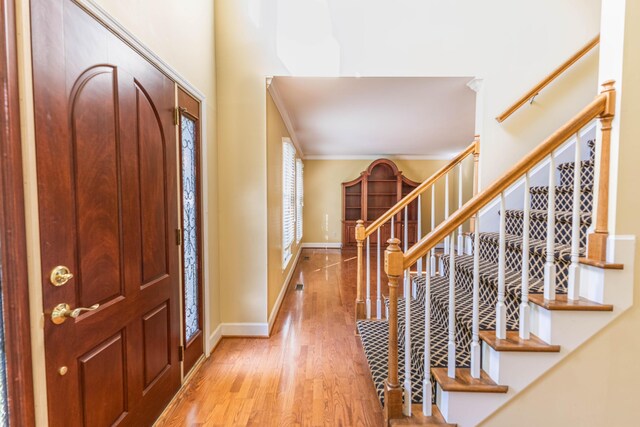6011 Canonero Way, Versailles, KY 40383 - entrance foyer featuring wood finished floors, baseboards, stairway, and crown molding