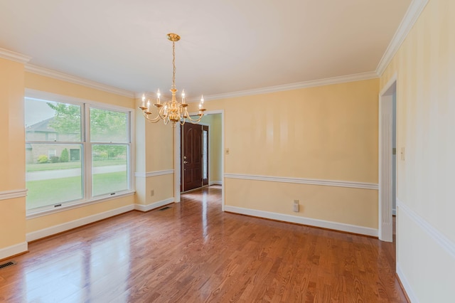 6011 Canonero Way, Versailles, KY 40383 - empty room featuring a chandelier, wood finished floors, ornamental molding, and baseboards