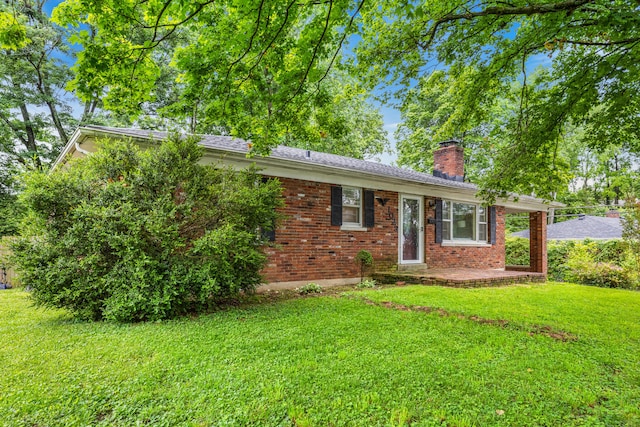 1023 Chickasaw Trl, Frankfort, KY 40601 - ranch-style house with a chimney, a front lawn, and brick siding